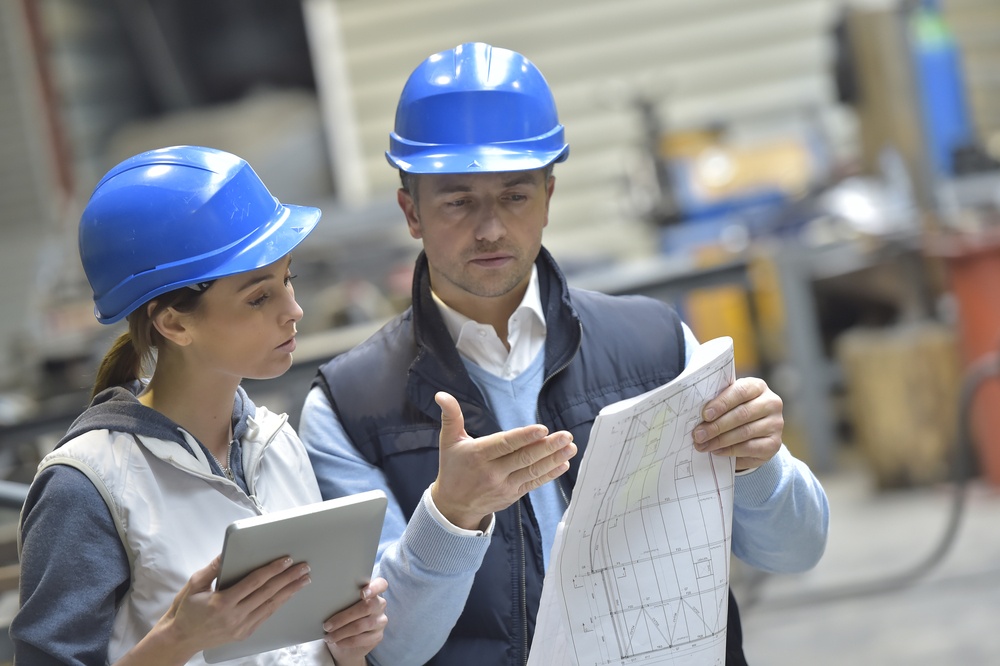 Engineers in mechanical factory reading instructions.jpeg